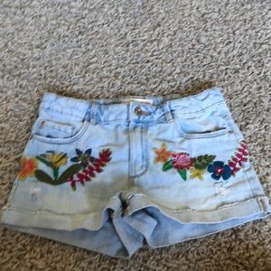 light wash cuffed and slightly distressed embroidered shorts